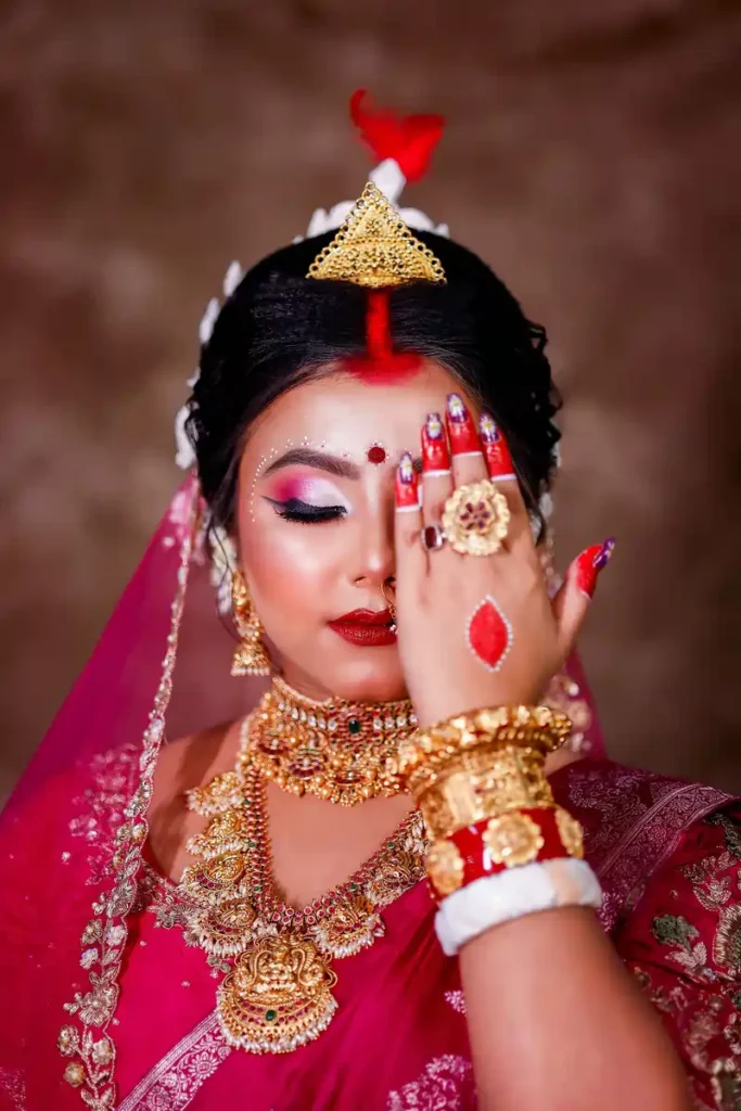 Bengali bride look by Chandrama Kalita featuring traditional bridal makeup and attire